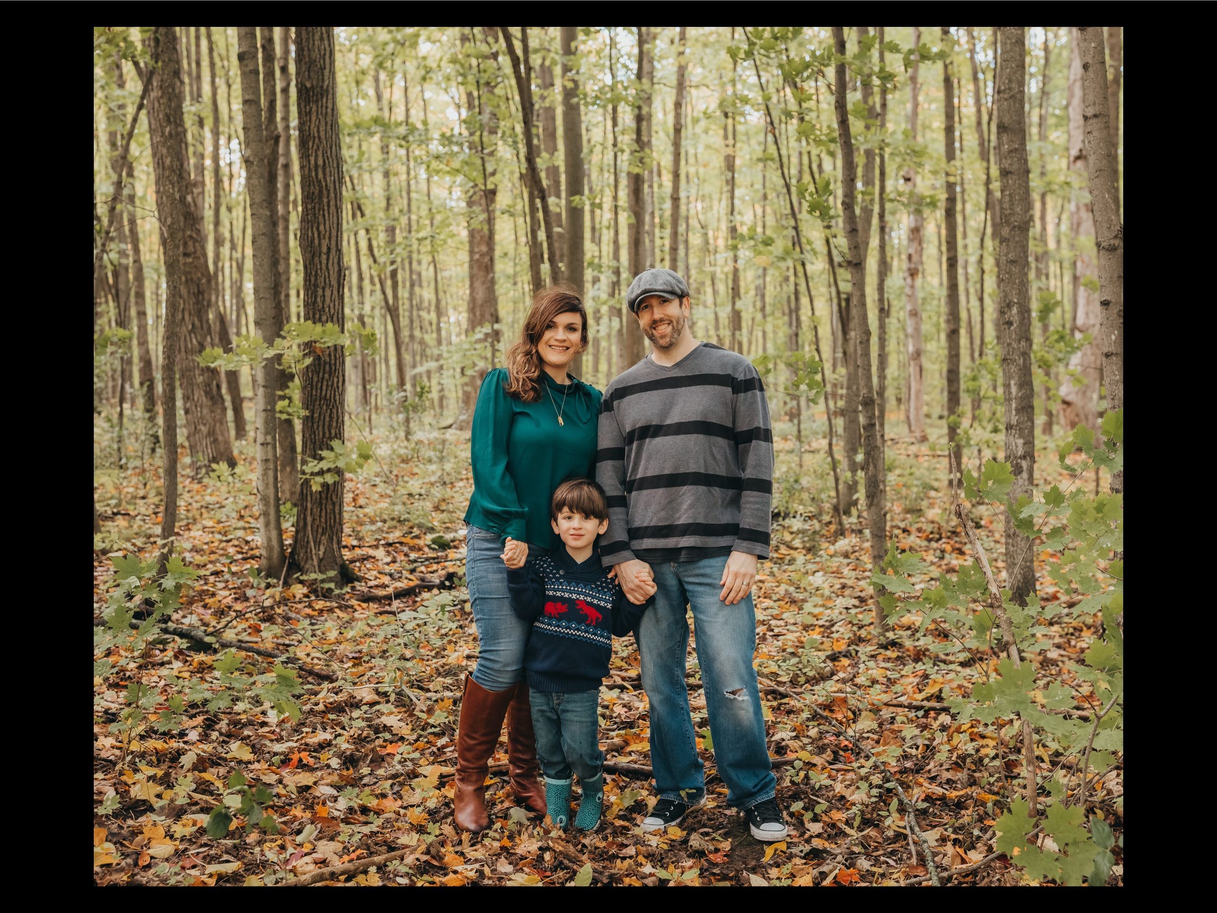 Homeowners Kelli & Scott and their child in the woods.