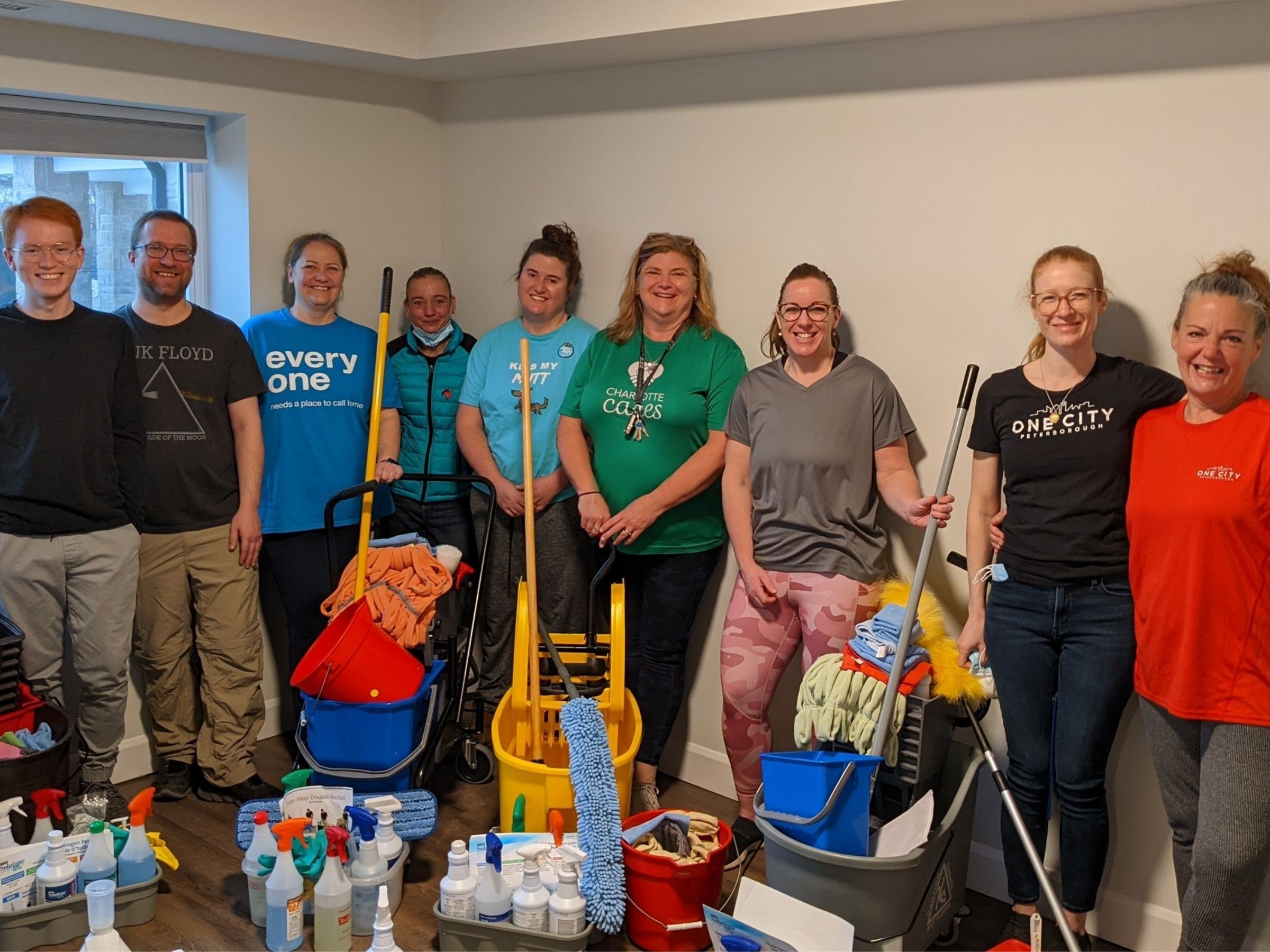 Charlotte Cares Volunteers standing with cleaning products