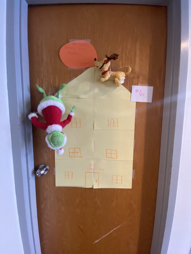Christmas door decorating entry number 5: The Grinch and his dog Max, climbing up the house