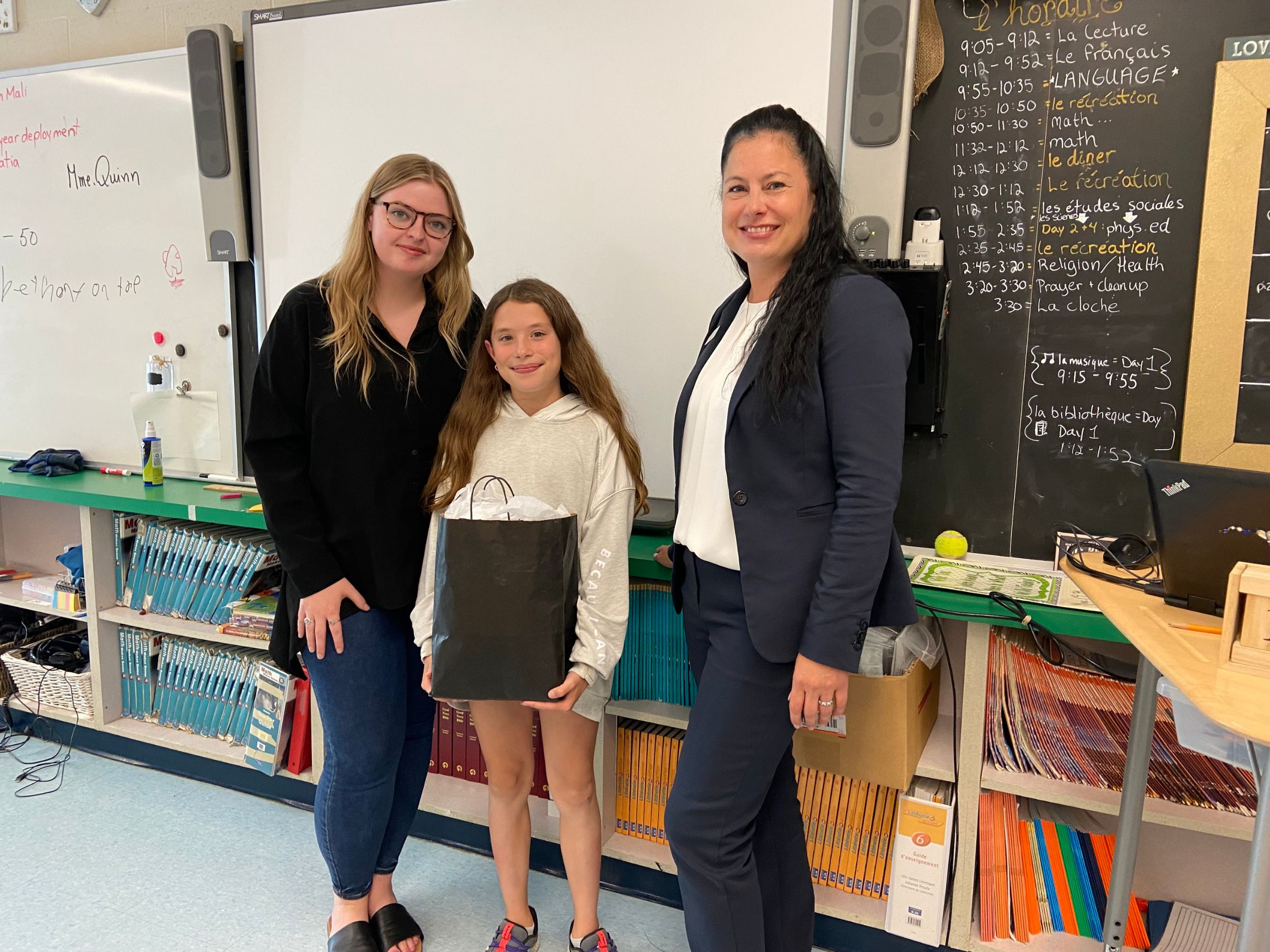 Habitat PKR Communications & Donor Services Manager Jenn MacDonald, Meaning of Home Runner-Up Winner Ellyot Wood, and SAGEN Representative Christina Ward at the pizza party celebration for Ellyot