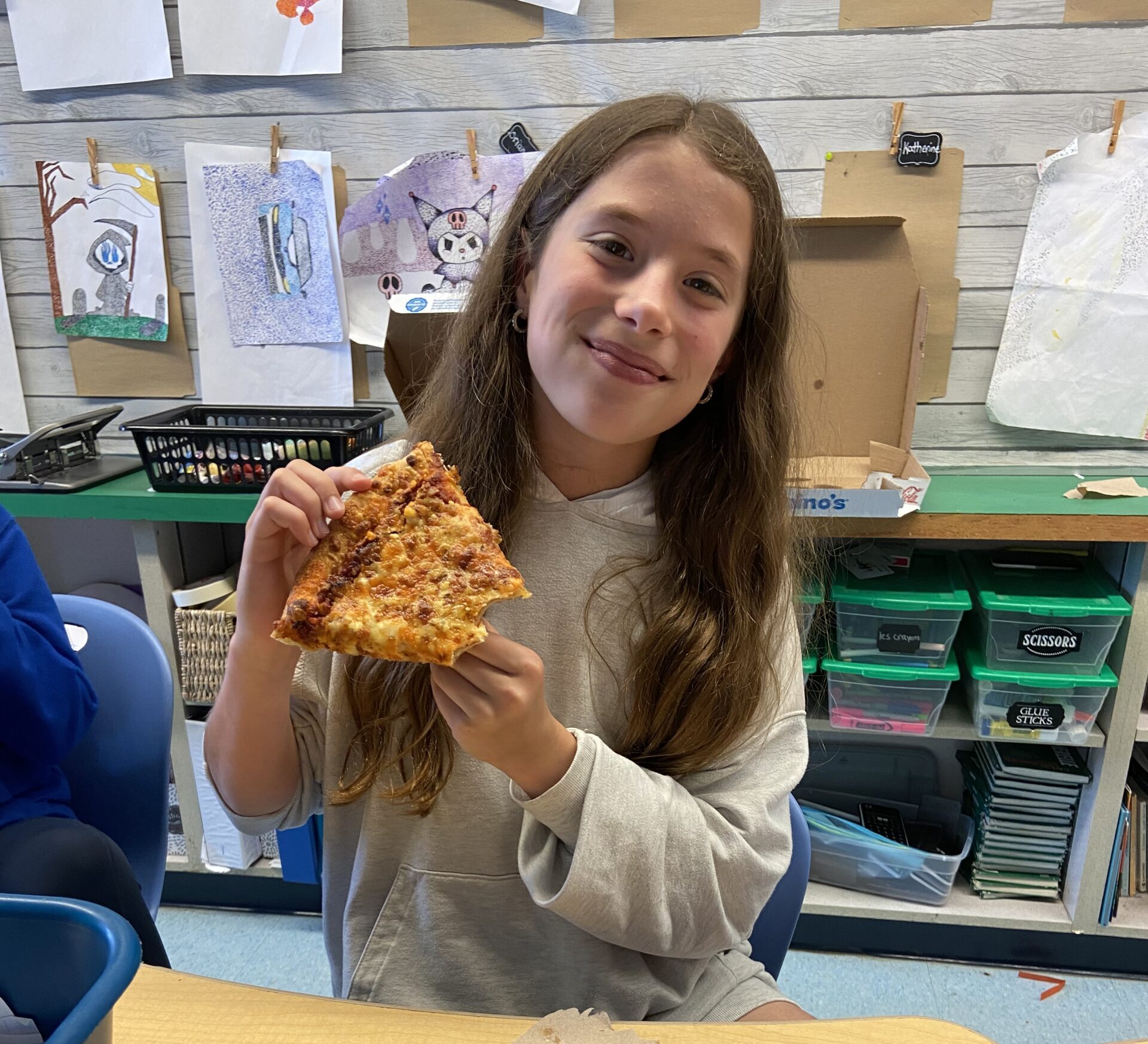 Photo of Ellyot enjoying pizza at her pizza party in school.