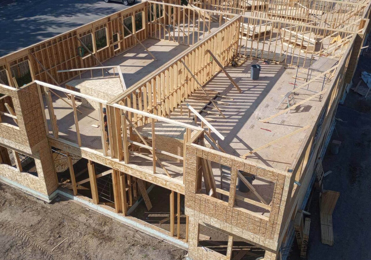 An overhead shot of an under construction 2 story home that is framed in with no roof
