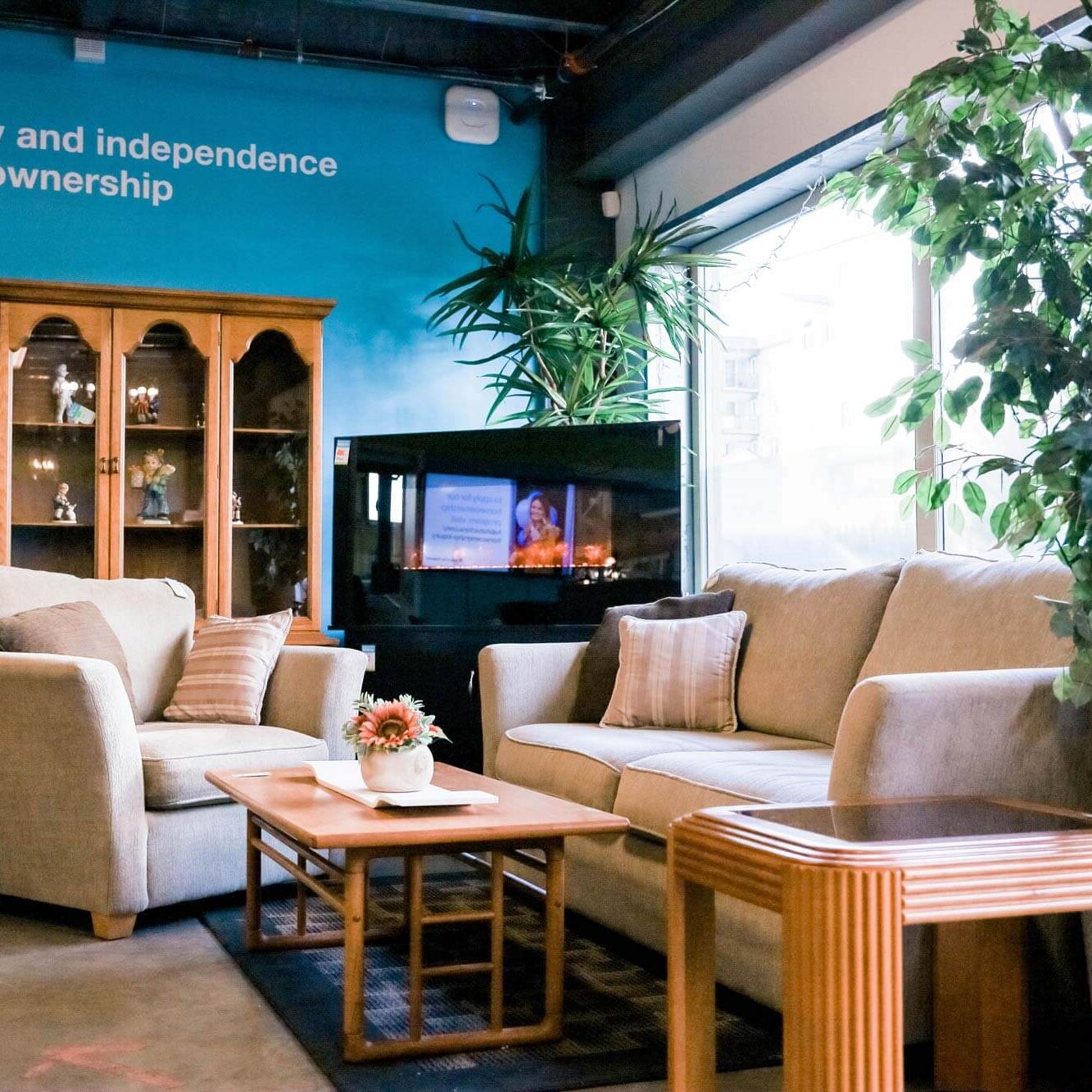 Photo of a corner of the ReStore, it is arranged with for sale furniture setup like a cozy living room
